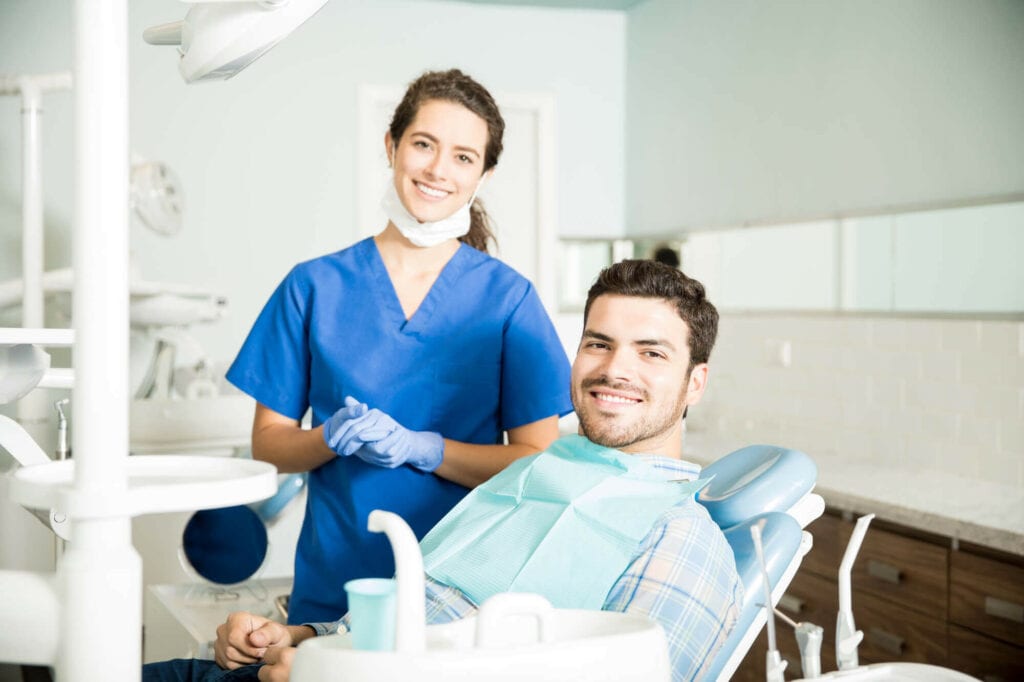 Young Female Dentist offering Support for Dental Emergencies to Her Male Pacient